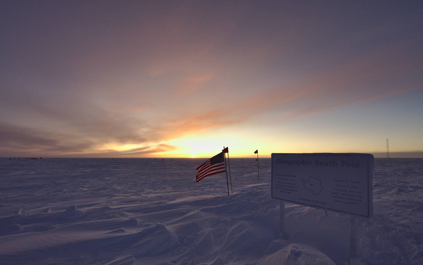 The geographic pole marker with the rising sun.